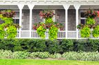 beautiful plants and flowers covering white front porch