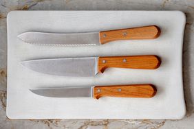 Three kitchen knives on cutting board